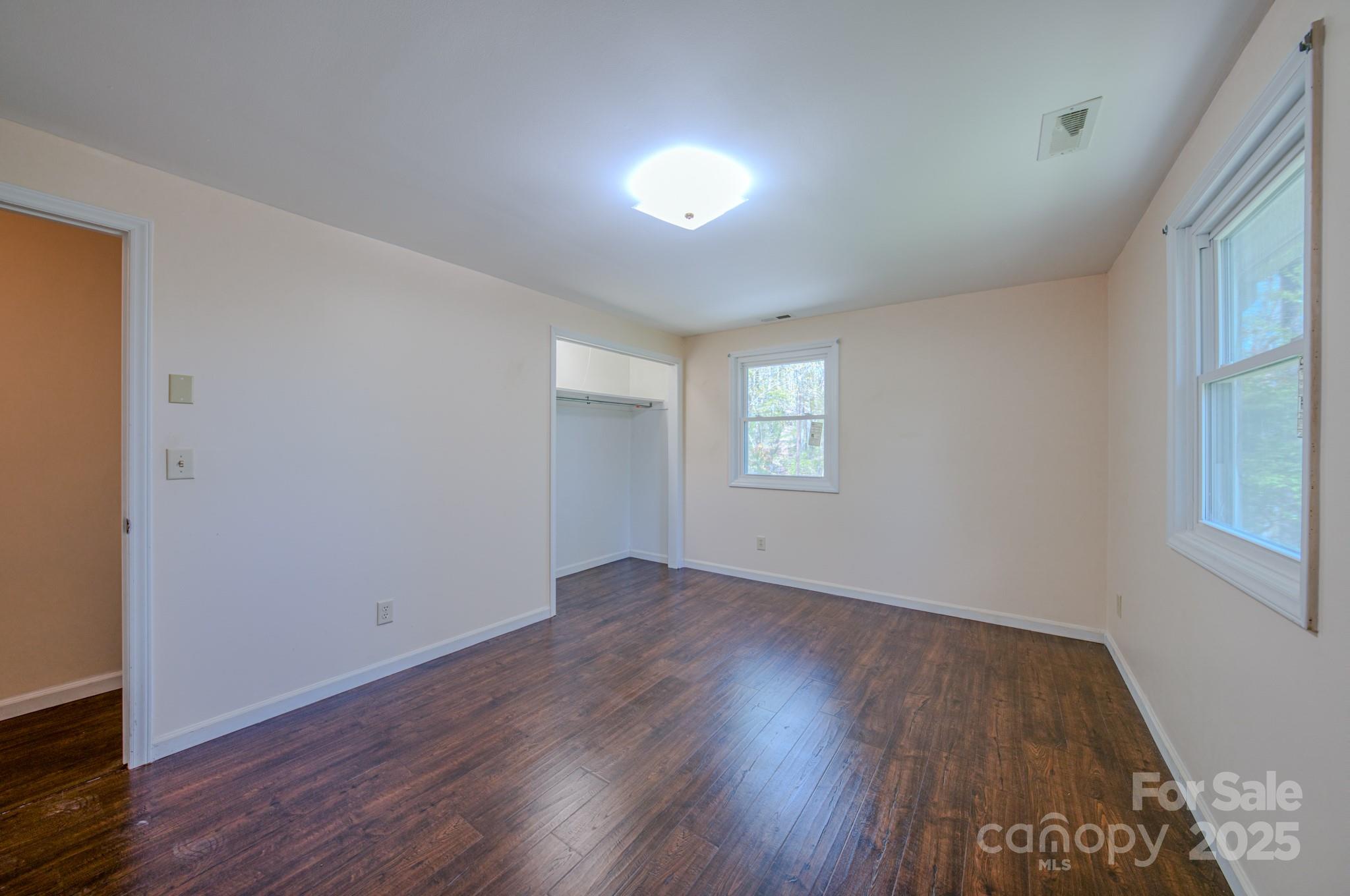 280 Fletcher View Drive Fletcher, NC 28732 - Photo 22 of 40 an empty room with wooden floor and windows