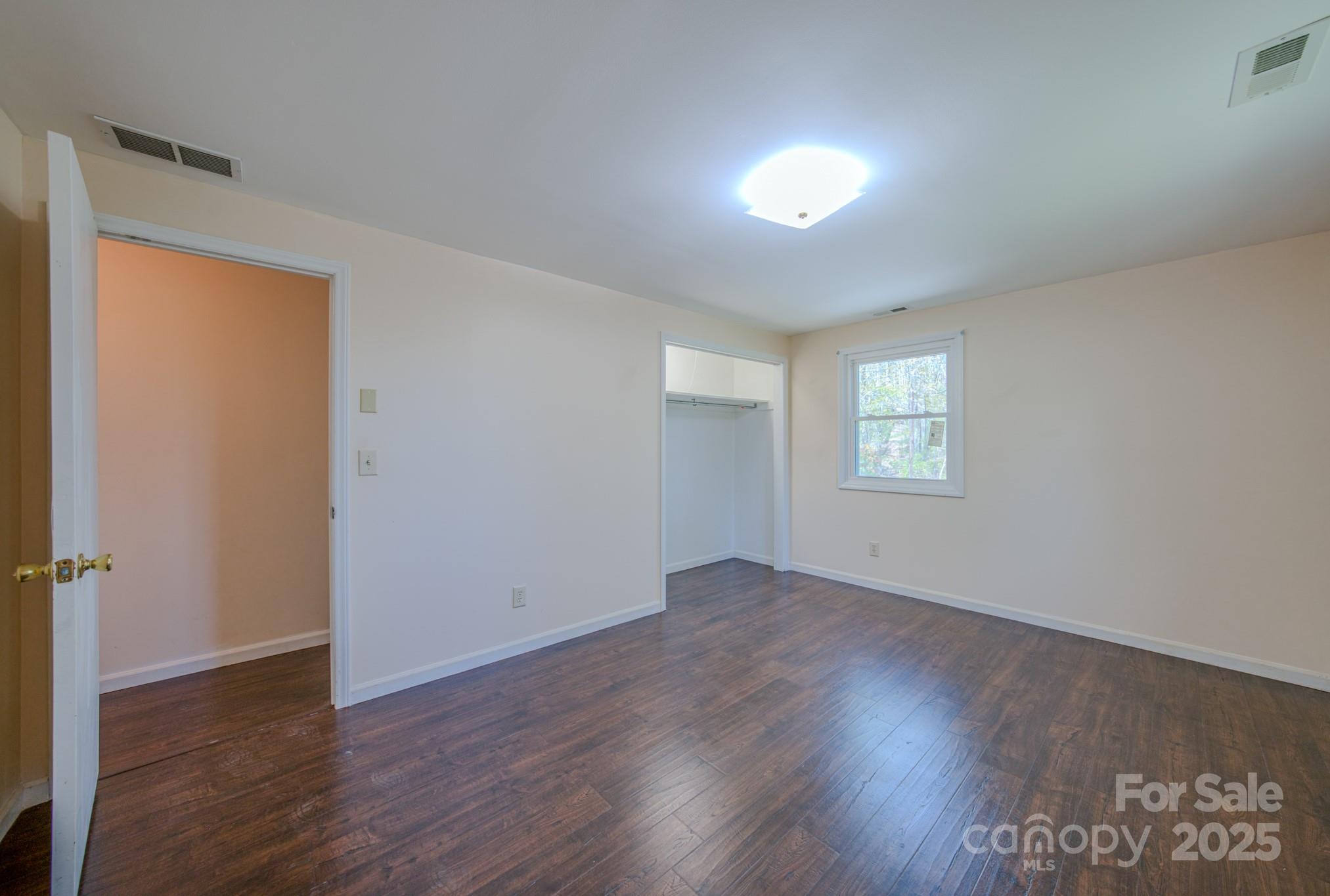 280 Fletcher View Drive Fletcher, NC 28732 - Photo 23 of 40 an empty room with wooden floor and windows