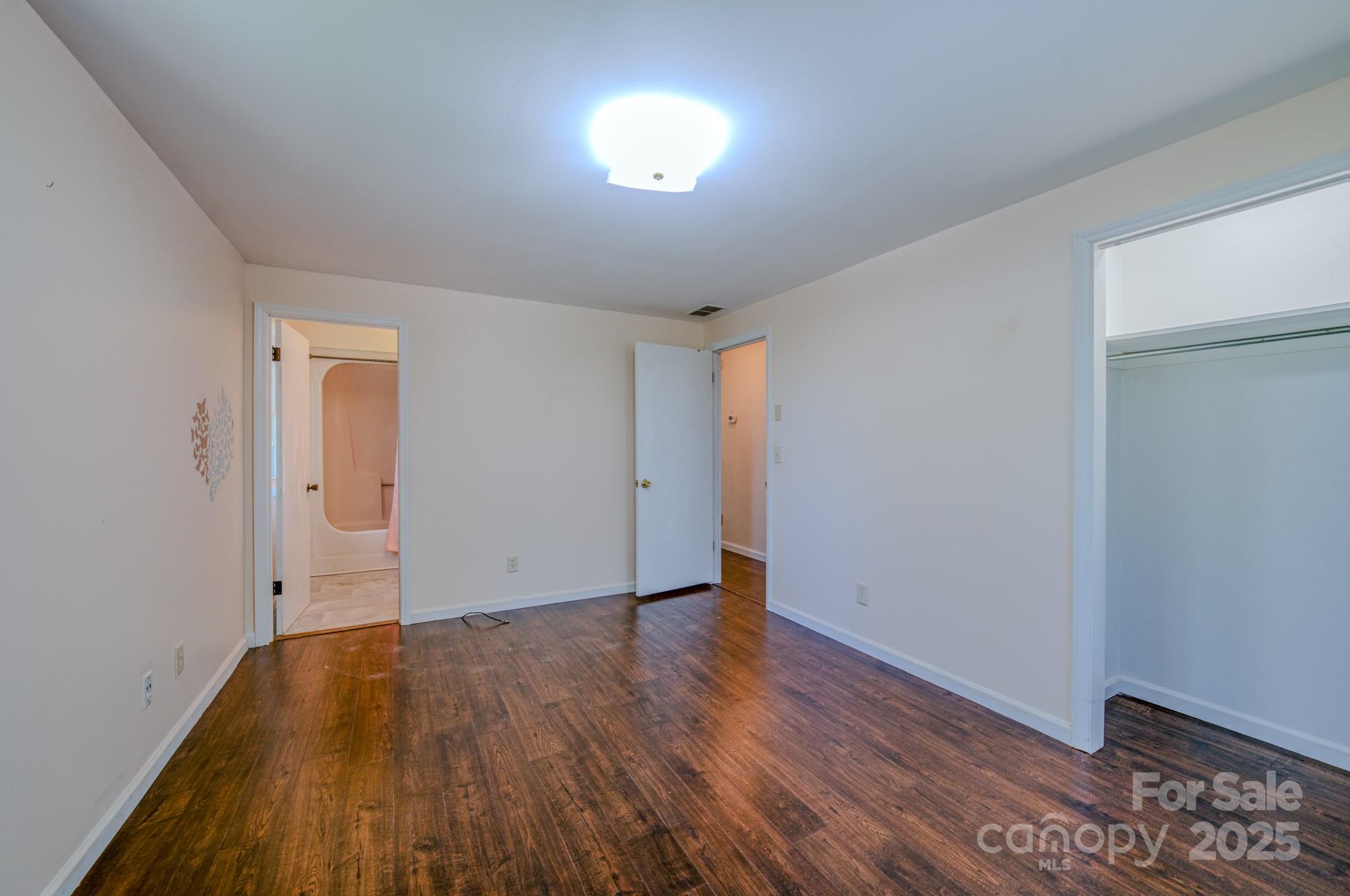 280 Fletcher View Drive Fletcher, NC 28732 - Photo 24 of 40 a view of empty room with wooden floor and fan