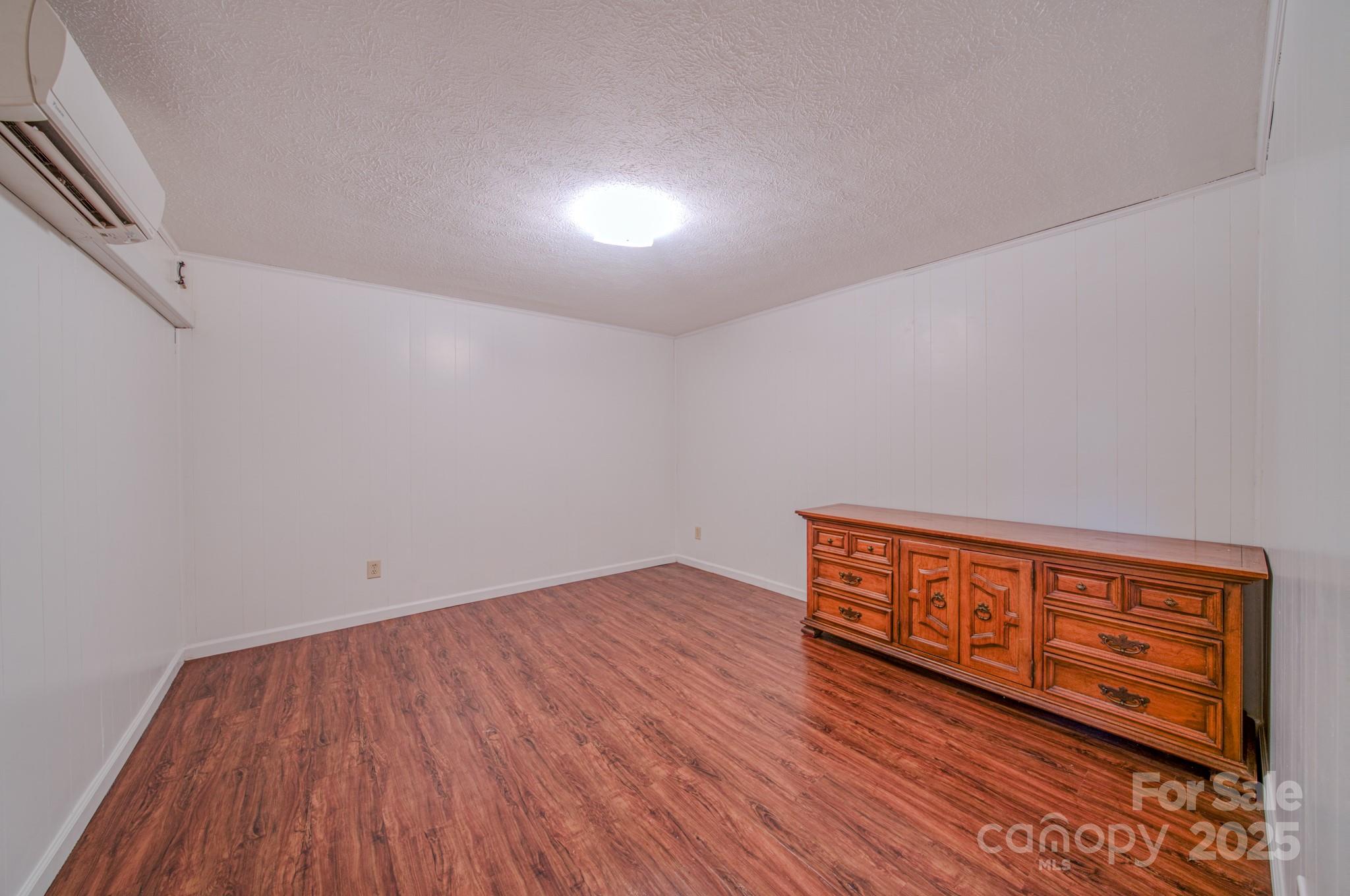 280 Fletcher View Drive Fletcher, NC 28732 - Photo 26 of 40 a view of an empty room with wooden floor and a window