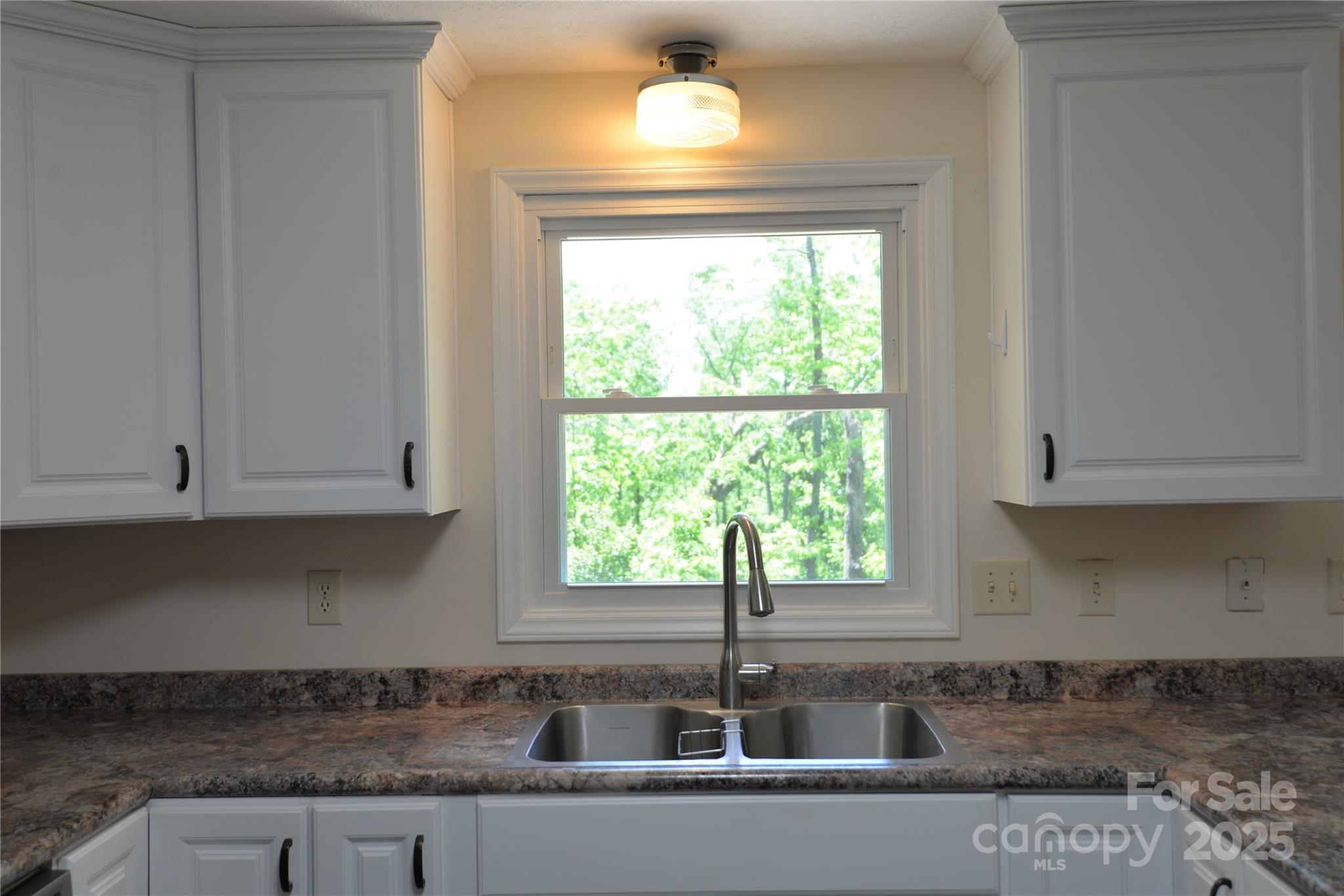 280 Fletcher View Drive Fletcher, NC 28732 - Photo 4 of 40 a kitchen with granite countertop a sink and white cabinets