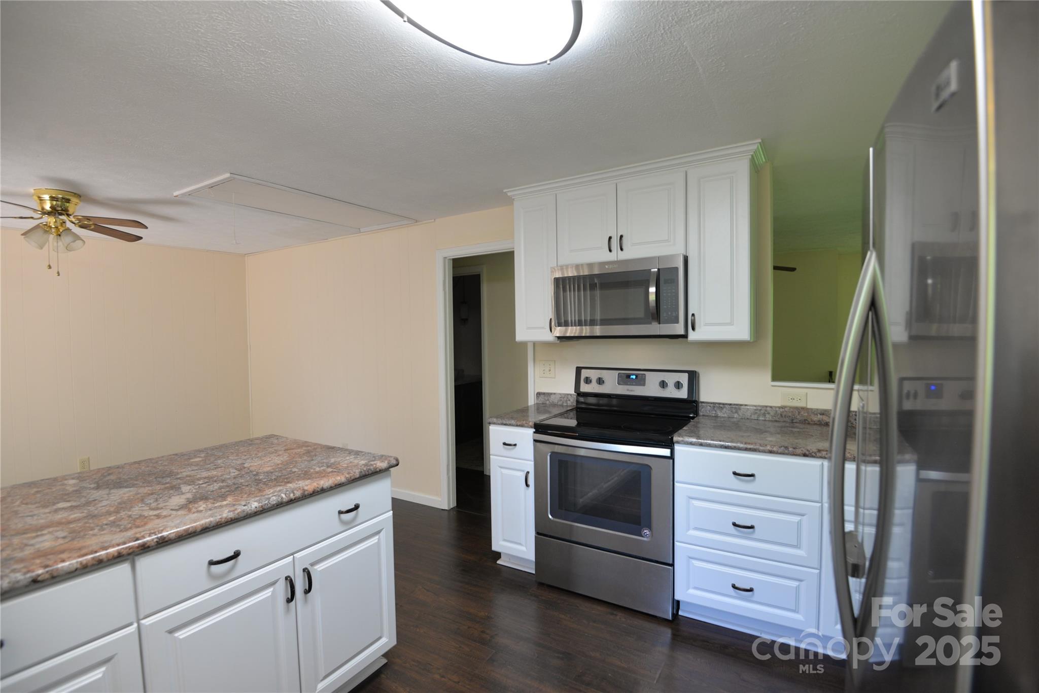 280 Fletcher View Drive Fletcher, NC 28732 - Photo 7 of 40 a kitchen with granite countertop a sink cabinets and stainless steel appliances