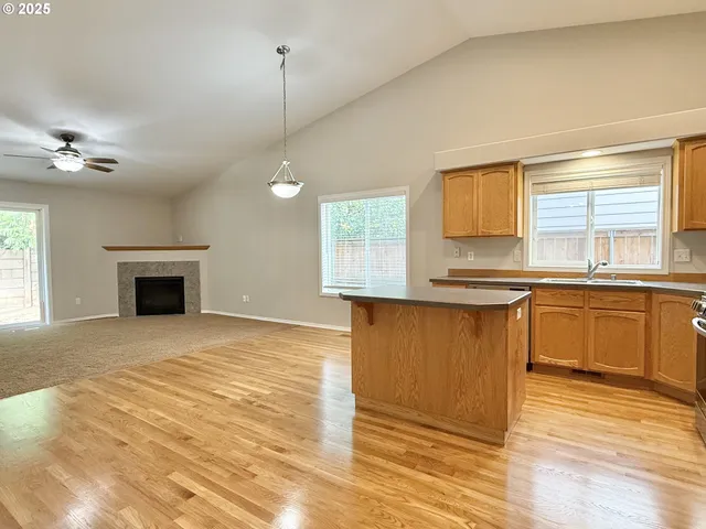 a kitchen with granite countertop a stove a sink and a microwave