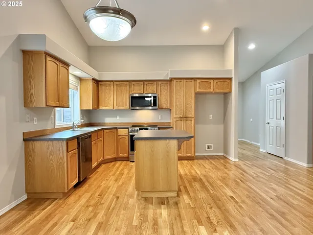 a kitchen with stainless steel appliances a refrigerator sink and cabinets