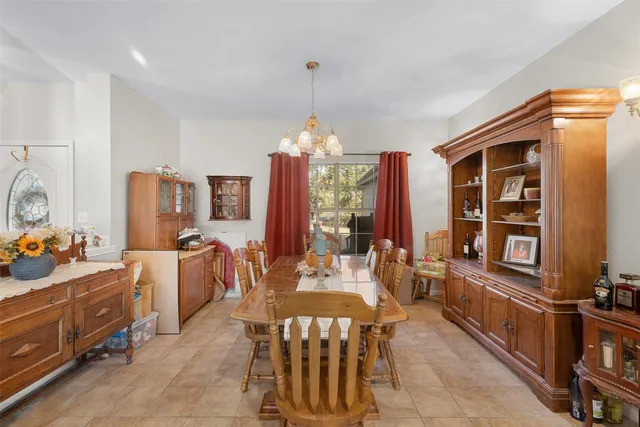 a living room with furniture a fireplace and a chandelier
