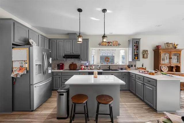 a kitchen with stainless steel appliances granite countertop a sink and cabinets