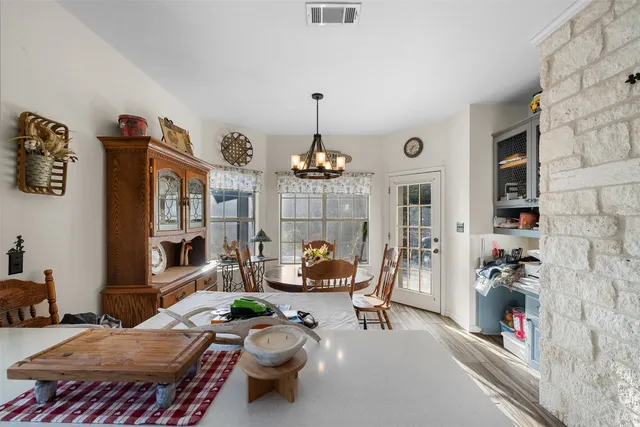 a view of a dry yard with wooden floor and fence