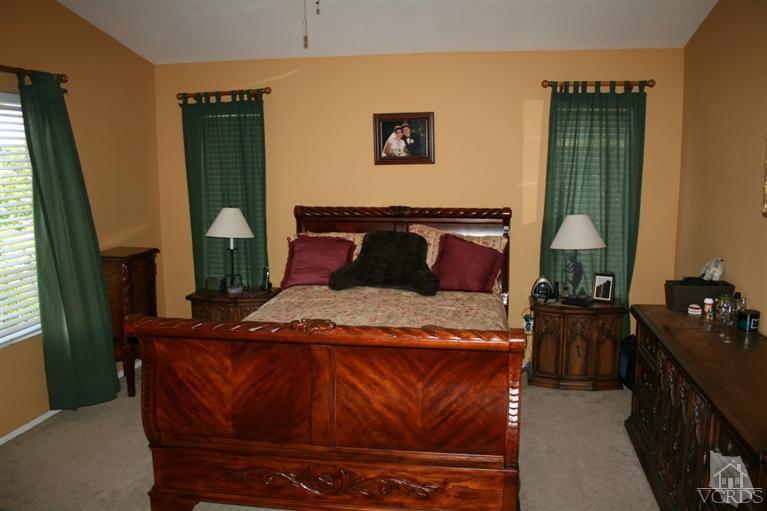 968 Roldan Avenue Simi Valley, CA 93065 - Photo 14 of 20 a bedroom with a bed and a mirror