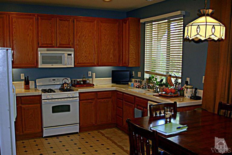 968 Roldan Avenue Simi Valley, CA 93065 - Photo 6 of 20 a kitchen with a stove a sink a counter space and cabinets
