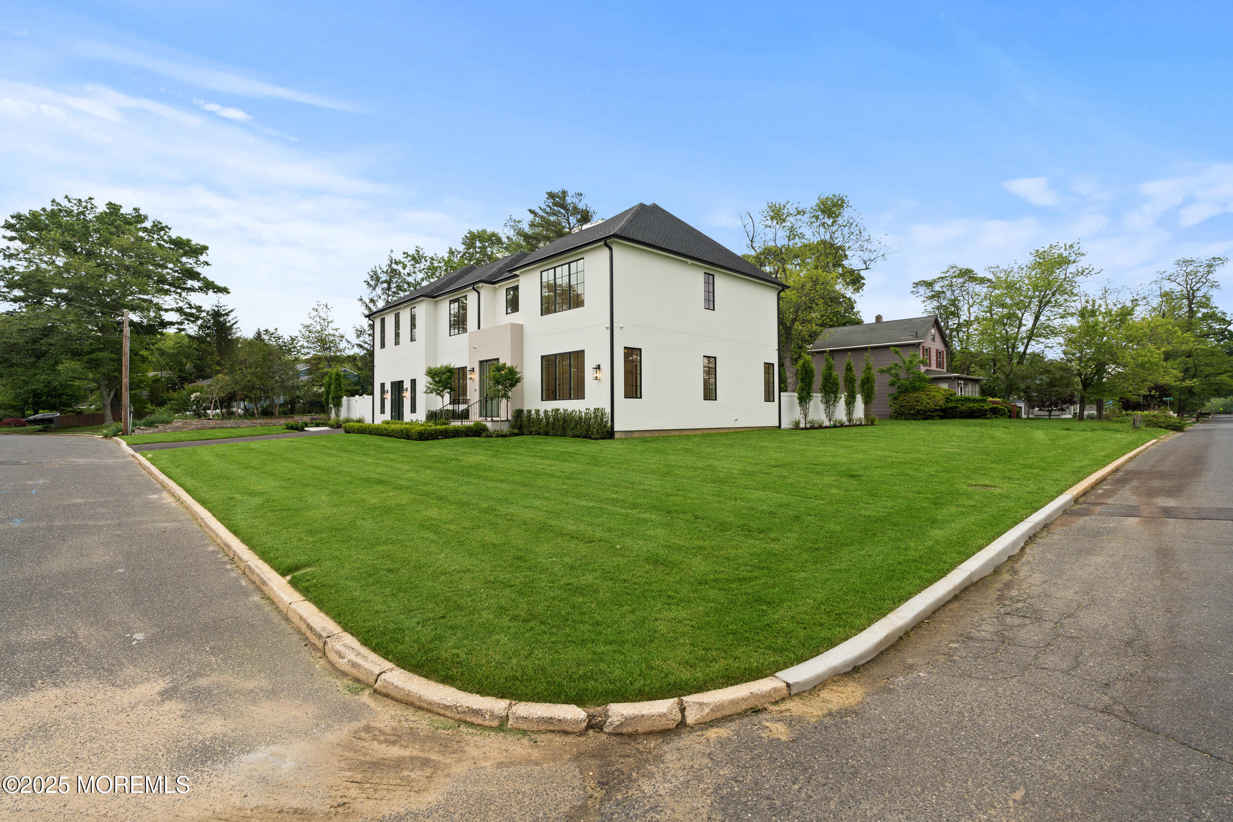 2 Deborah Place Oakhurst, NJ 07755 - Photo 3 of 82 a view of a white house in a big yard with large trees