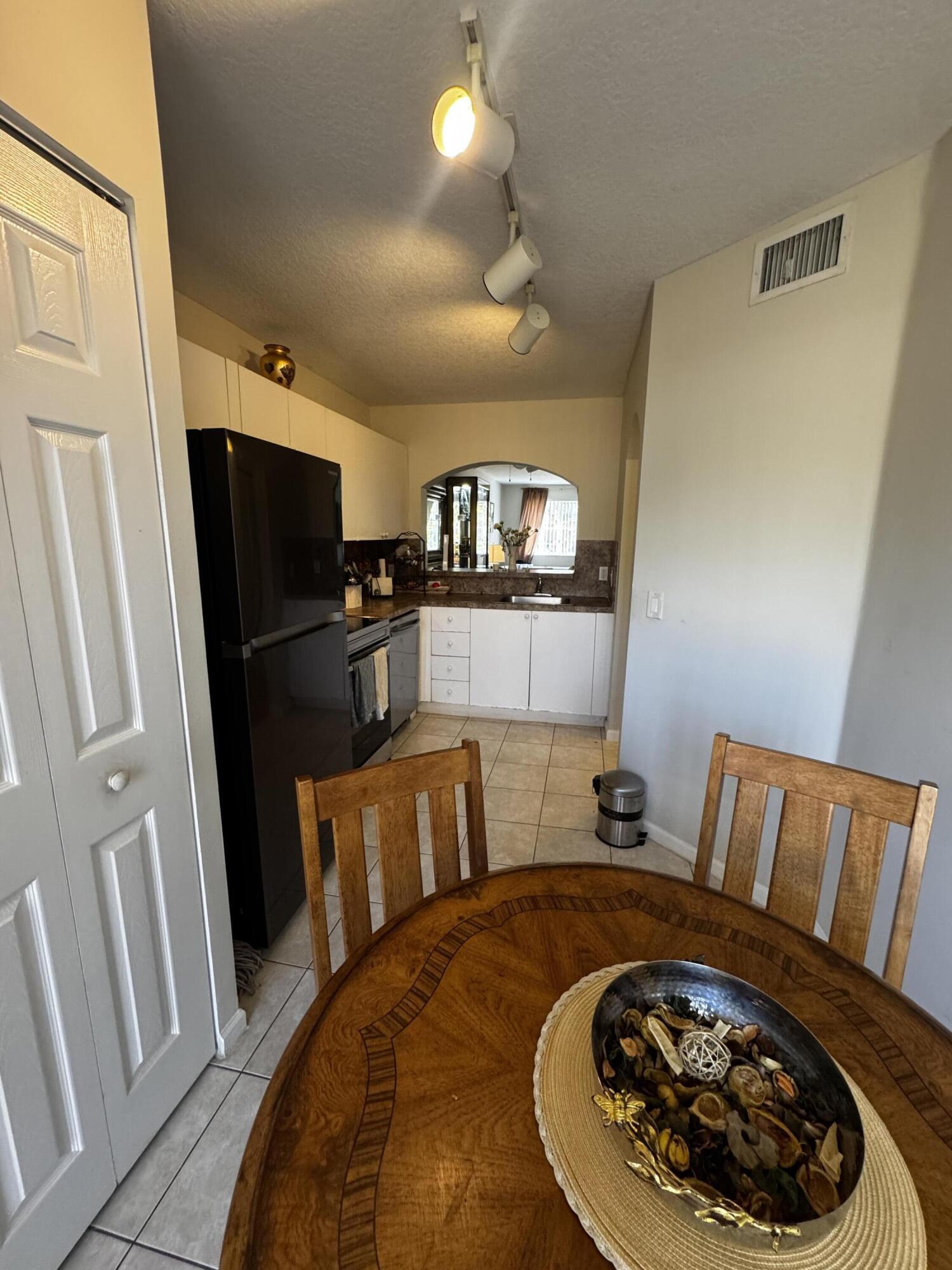 3810 North Jog Road, Unit 105 Royal Palm Beach, FL 33411 - Photo 19 of 26 a bed room with a bed and a television