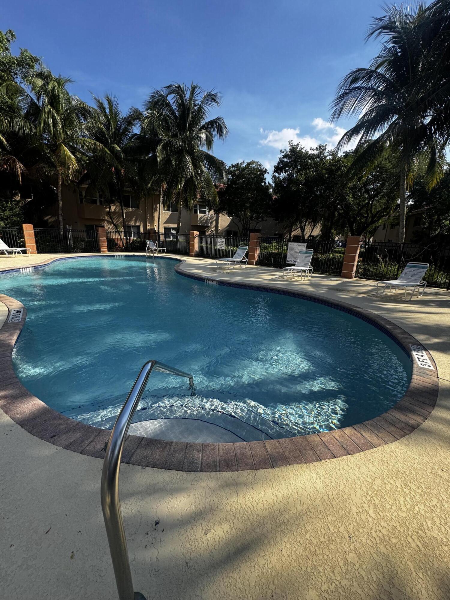 3810 North Jog Road, Unit 105 Royal Palm Beach, FL 33411 - Photo 23 of 26 a view of a swimming pool with a garden
