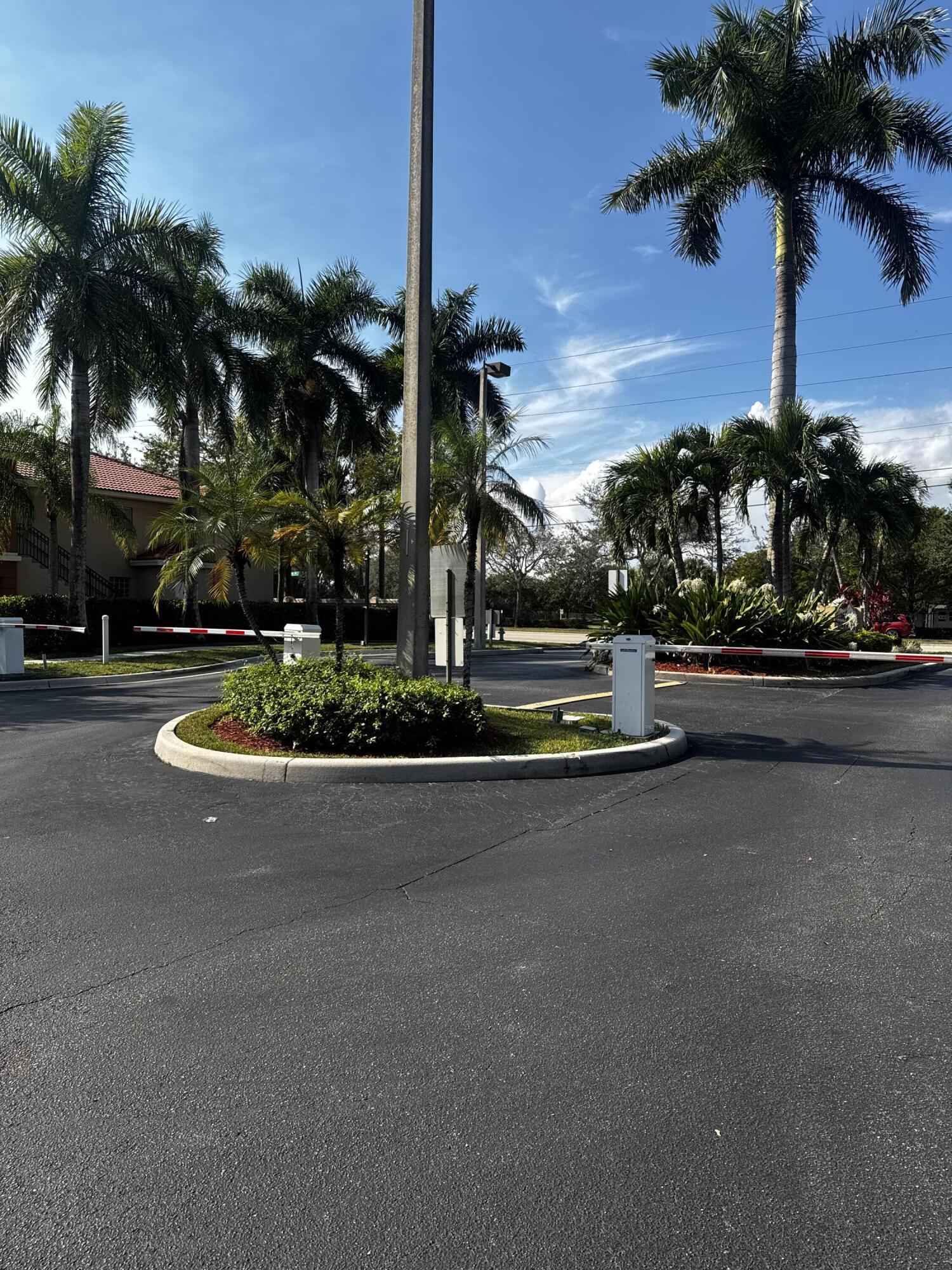 3810 North Jog Road, Unit 105 Royal Palm Beach, FL 33411 - Photo 25 of 26 a view of a street with palm trees