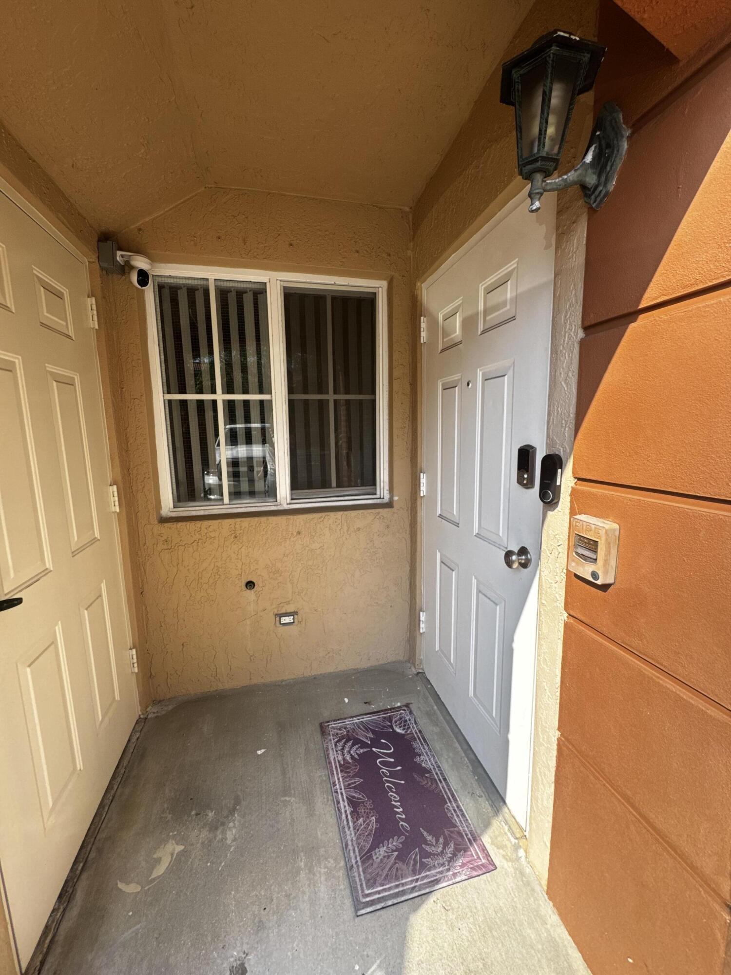 3810 North Jog Road, Unit 105 Royal Palm Beach, FL 33411 - Photo 3 of 26 a view of front door of a house