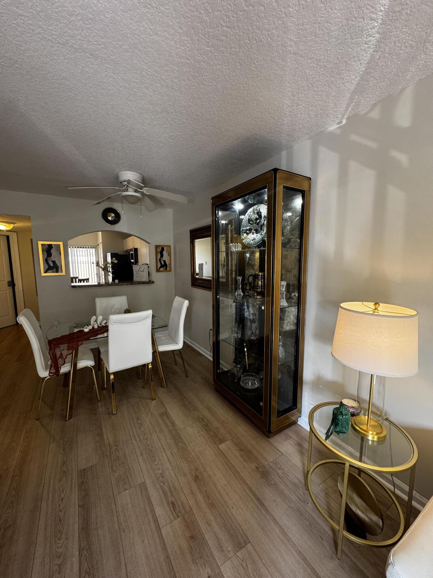 3810 North Jog Road, Unit 105 Royal Palm Beach, FL 33411 - Photo 7 of 26 a living room with furniture and wooden floor