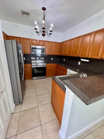 a kitchen with stainless steel appliances granite countertop a sink counter space cabinets and a counter top space