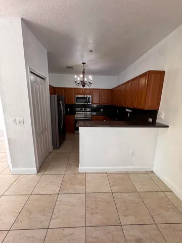 a kitchen with stainless steel appliances a counter space and cabinets
