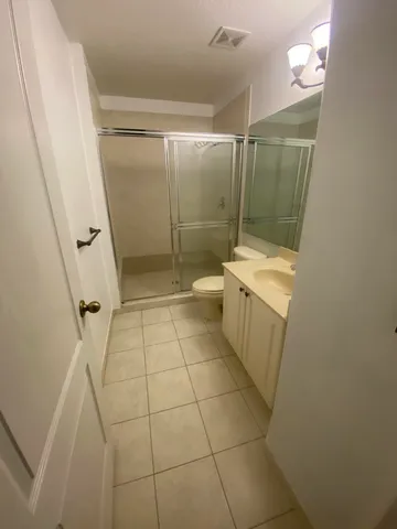 a bathroom with a shower and a toilet