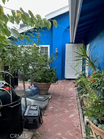 a couple of potted plants in front of door