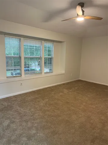 an empty room with a empty space and windows