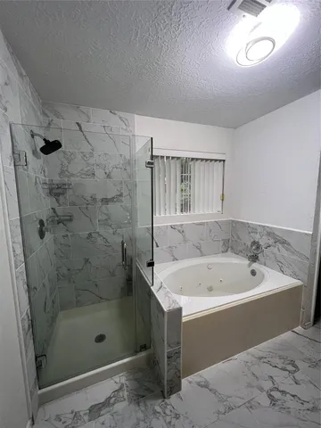 a bathroom with a sink a mirror and a bathtub