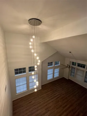 a view of a kitchen with furniture and wooden floor