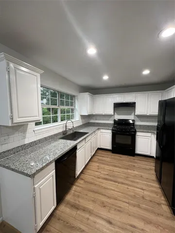 a kitchen with granite countertop counter top space a sink stainless steel appliances and cabinets