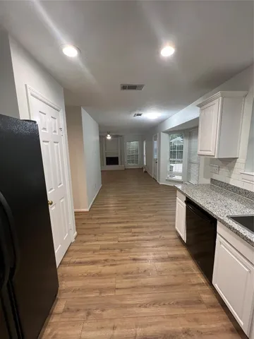 a view of a kitchen cabinets and a wooden floor