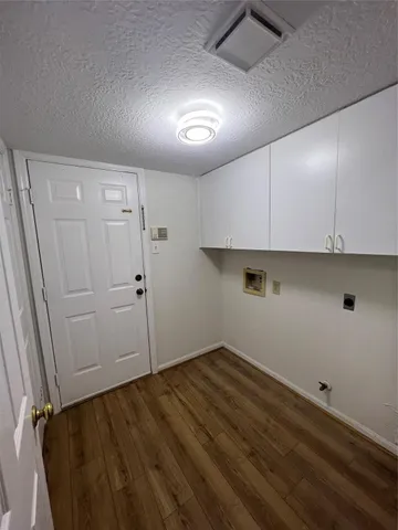 a view of storage and utility room with wooden floor