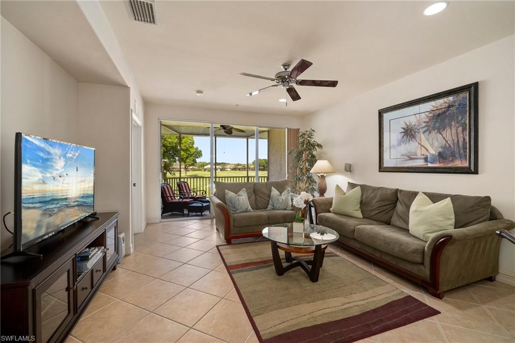 9113 Michael Circle, Unit 4 Naples, FL 34113 - Photo 12 of 23 Tiled living room with ceiling fan