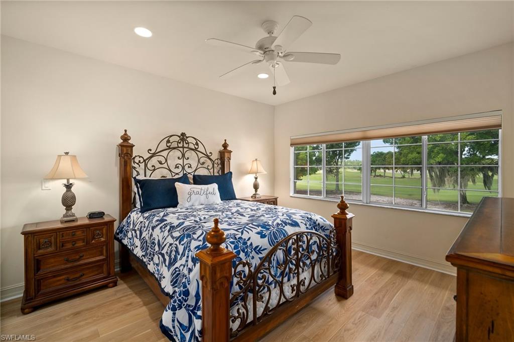 9113 Michael Circle, Unit 4 Naples, FL 34113 - Photo 18 of 23 Bedroom with ceiling fan and light wood-type flooring