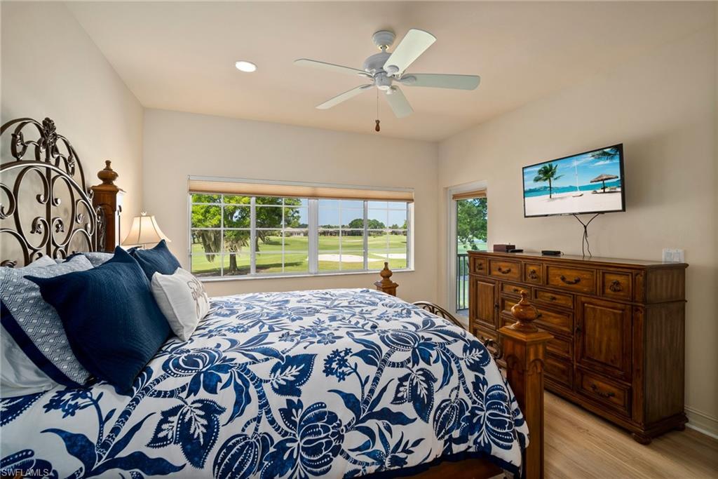 9113 Michael Circle, Unit 4 Naples, FL 34113 - Photo 19 of 23 Bedroom with ceiling fan and light hardwood / wood-style floors
