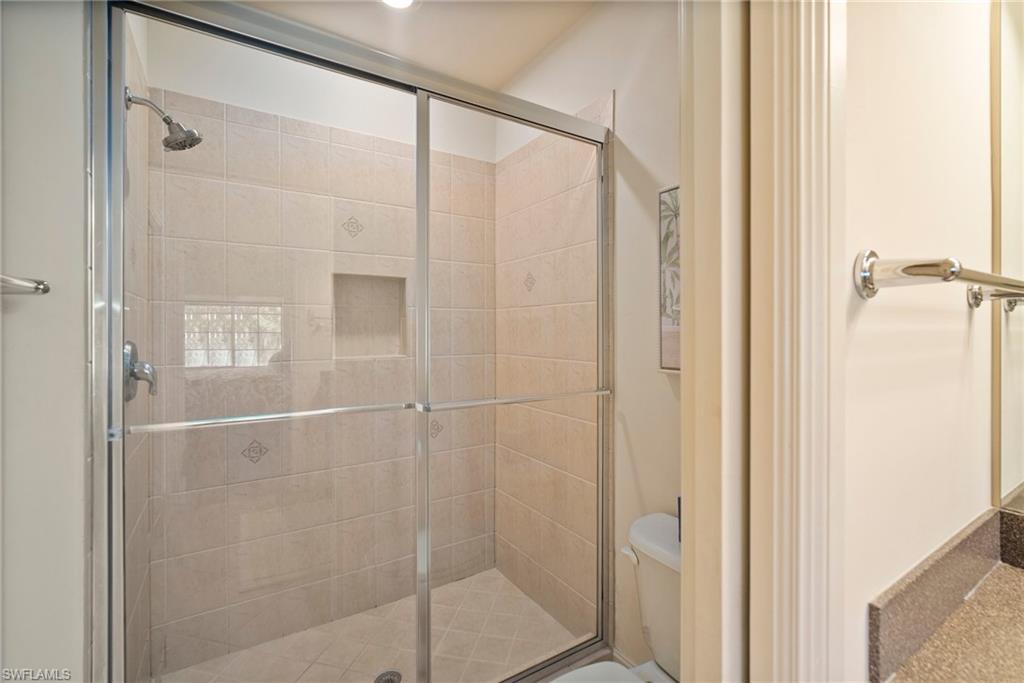 9113 Michael Circle, Unit 4 Naples, FL 34113 - Photo 21 of 23 Bathroom featuring walk in shower and toilet
