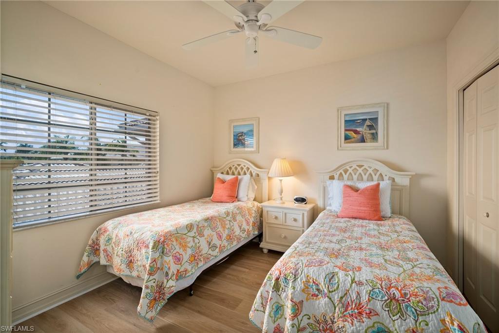 9113 Michael Circle, Unit 4 Naples, FL 34113 - Photo 4 of 23 Bedroom featuring ceiling fan, a closet, and wood-type flooring