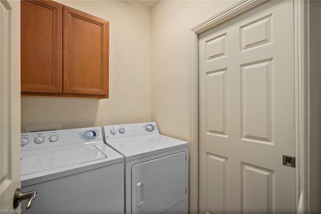 9113 Michael Circle, Unit 4 Naples, FL 34113 - Photo 10 of 23 Washroom with separate washer and dryer and cabinets