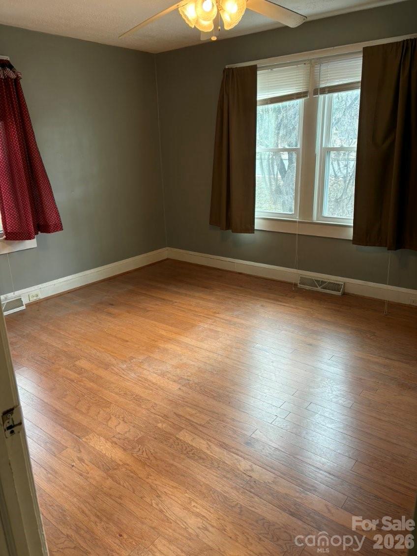 1507 Fayetteville Road Rockingham, NC 28379 - Photo 16 of 28 a view of an empty room with wooden floor and a window