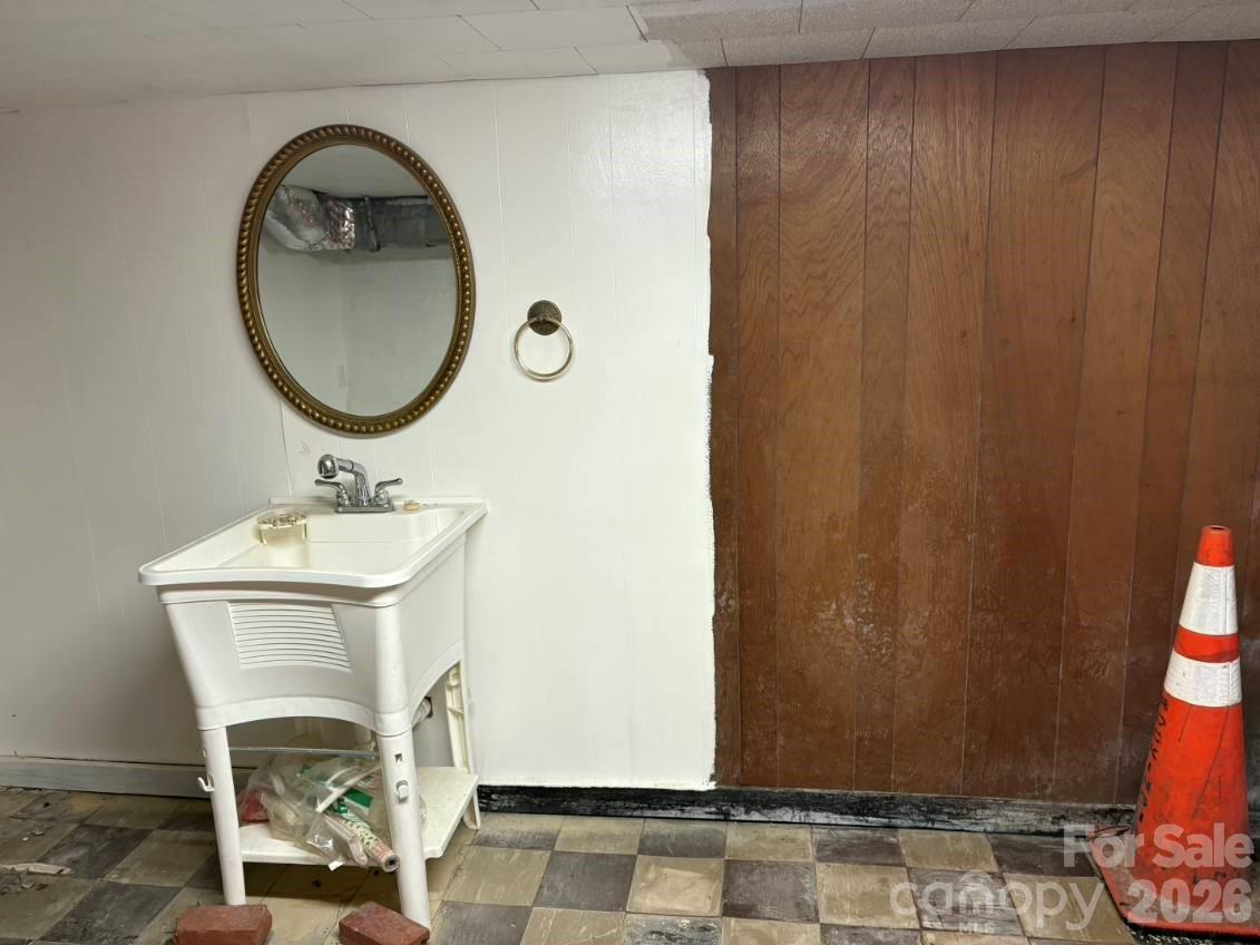 1507 Fayetteville Road Rockingham, NC 28379 - Photo 22 of 28 a bathroom with a sink a mirror and a shower