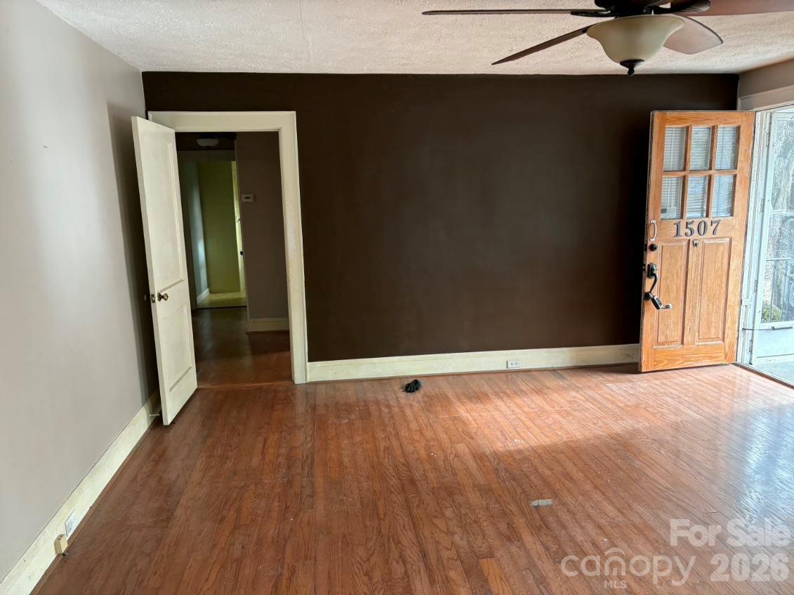 1507 Fayetteville Road Rockingham, NC 28379 - Photo 4 of 28 an empty room with wooden floor and windows