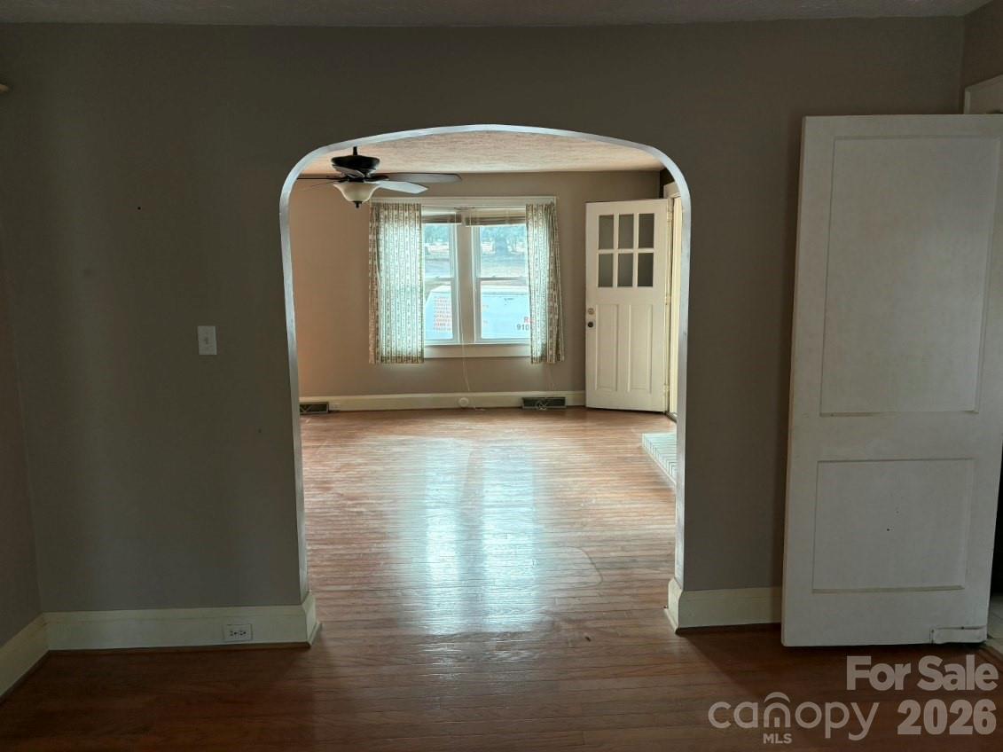1507 Fayetteville Road Rockingham, NC 28379 - Photo 5 of 28 a view of empty room with wooden floor and fan