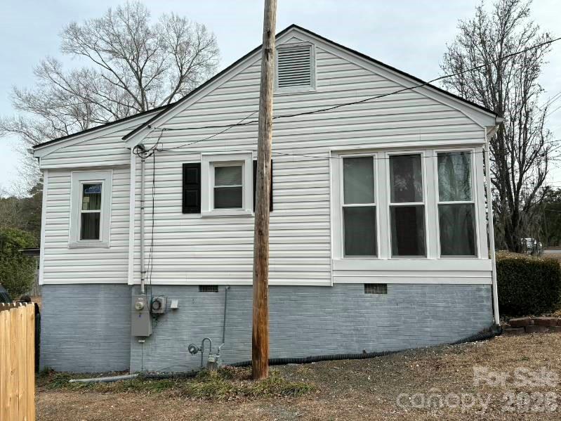 1507 Fayetteville Road Rockingham, NC 28379 - Photo 6 of 28 a view of a white house with large windows