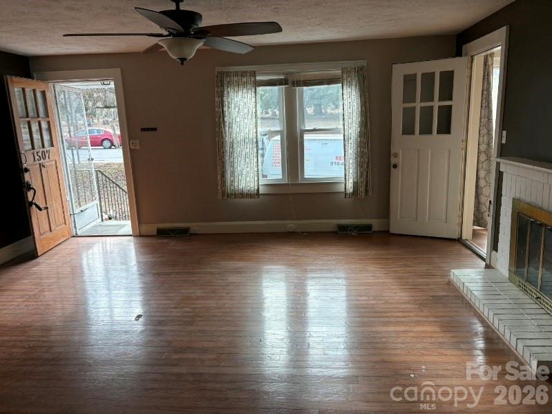 1507 Fayetteville Road Rockingham, NC 28379 - Photo 8 of 28 a view of empty room with wooden floor and fan