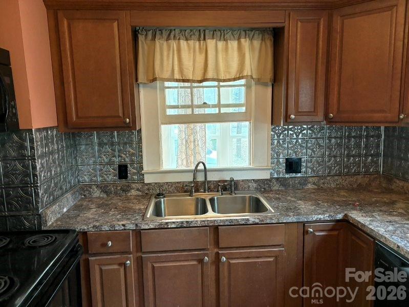 1507 Fayetteville Road Rockingham, NC 28379 - Photo 9 of 28 a kitchen with granite countertop a sink a stove and cabinets
