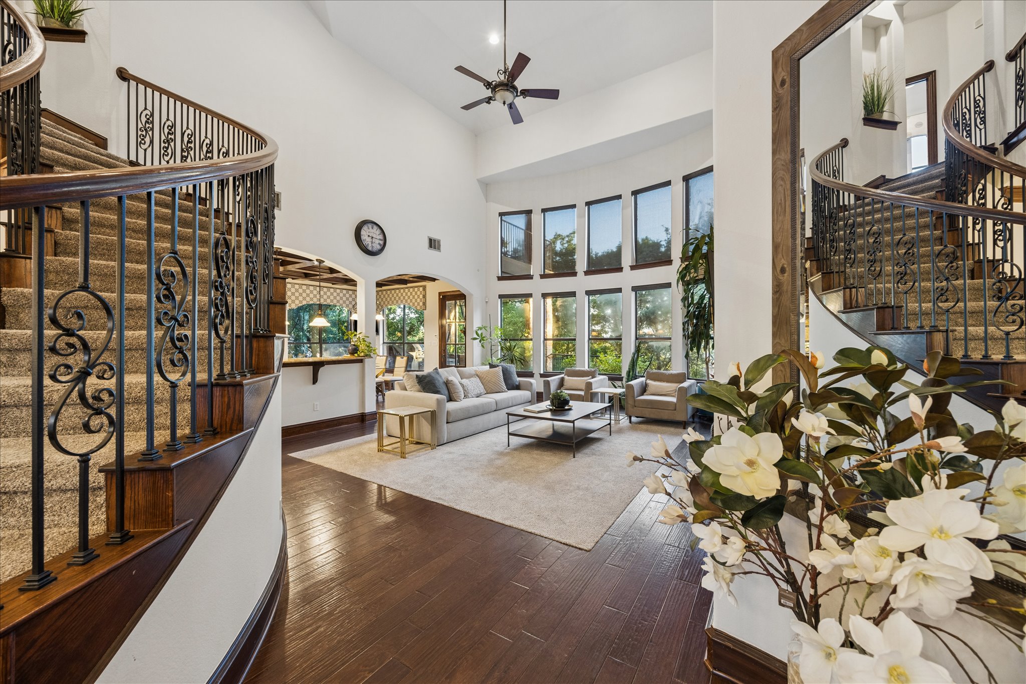 11805 Ranchview Court Austin, TX 78732 - Photo 6 of 36 Grand entry featuring a curved staircase with wrought iron balusters and dark wood treads