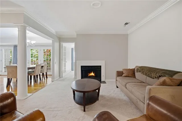 a living room with furniture a dining table and a fireplace