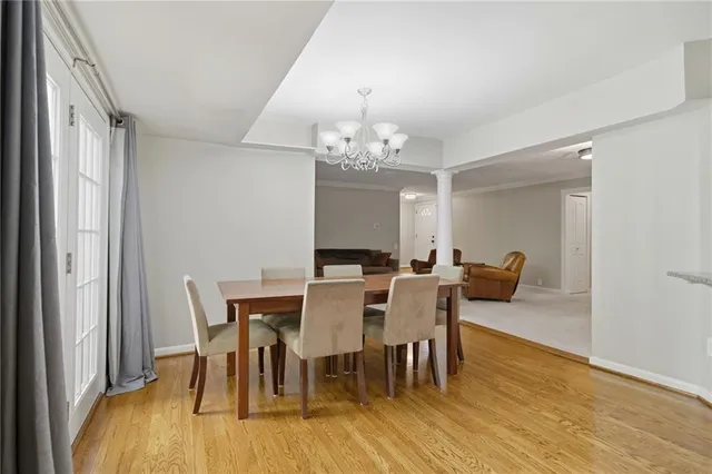 a view of a kitchen with wooden floor and a window