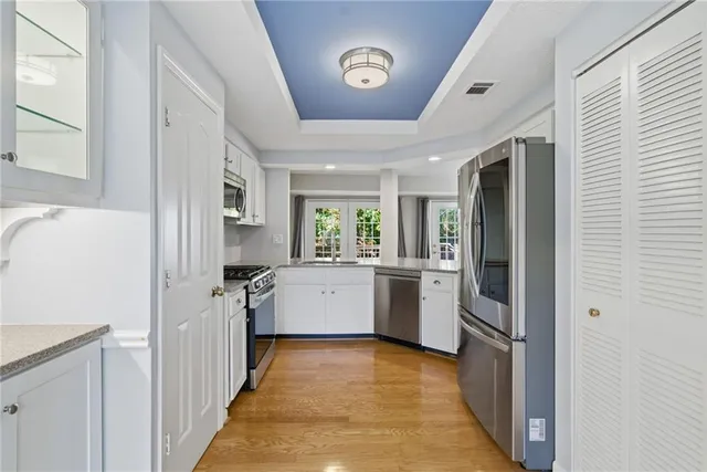 a kitchen with a refrigerator a stove top oven a sink and dishwasher