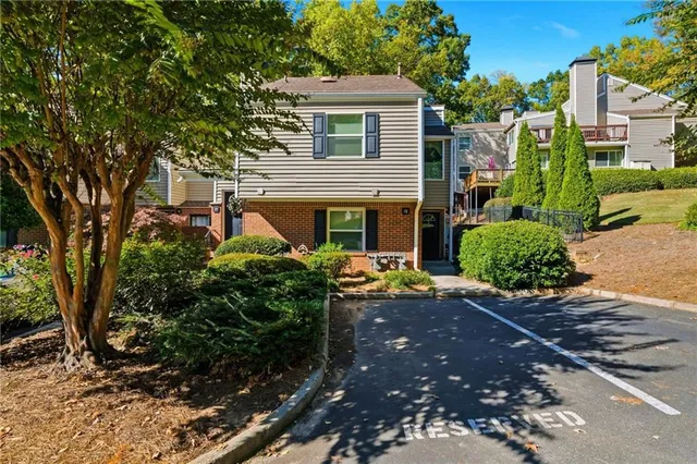 a view of a house with a tree and plants