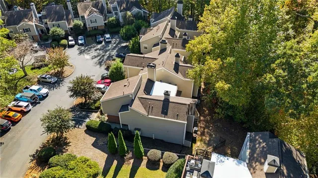 an aerial view of a house with a yard and wooden fence