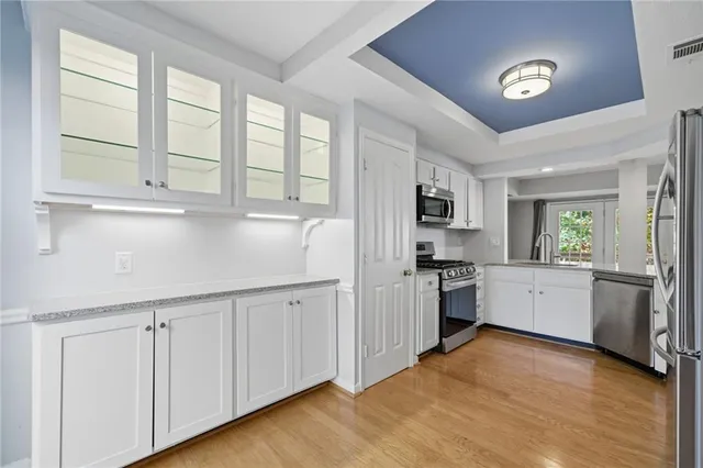 a kitchen with stainless steel appliances granite countertop a stove and a sink