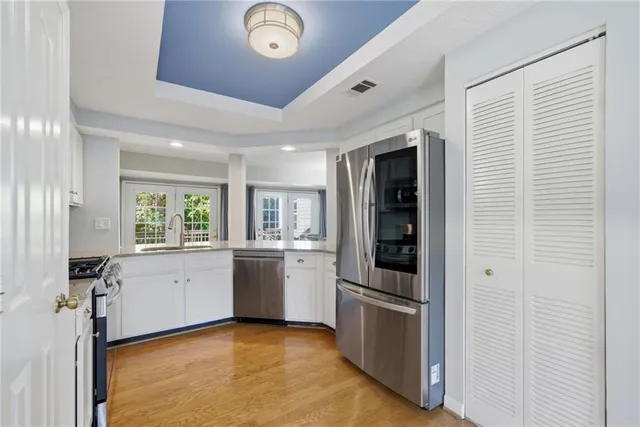 a kitchen with stainless steel appliances granite countertop a refrigerator and a stove top oven